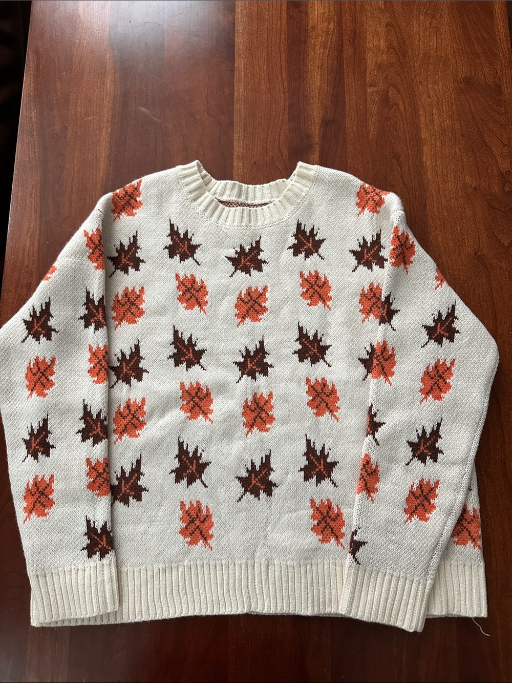 Cream Knit Sweater with Orange & Brown Leaf Motif.